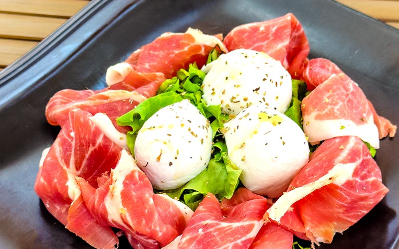 PalmBeach Tropical Restaurant | Parma Ham and Buffalo Mozzarella | 18-month aged parma cured ham, buffalo mozzarella, oregano, and lettuce